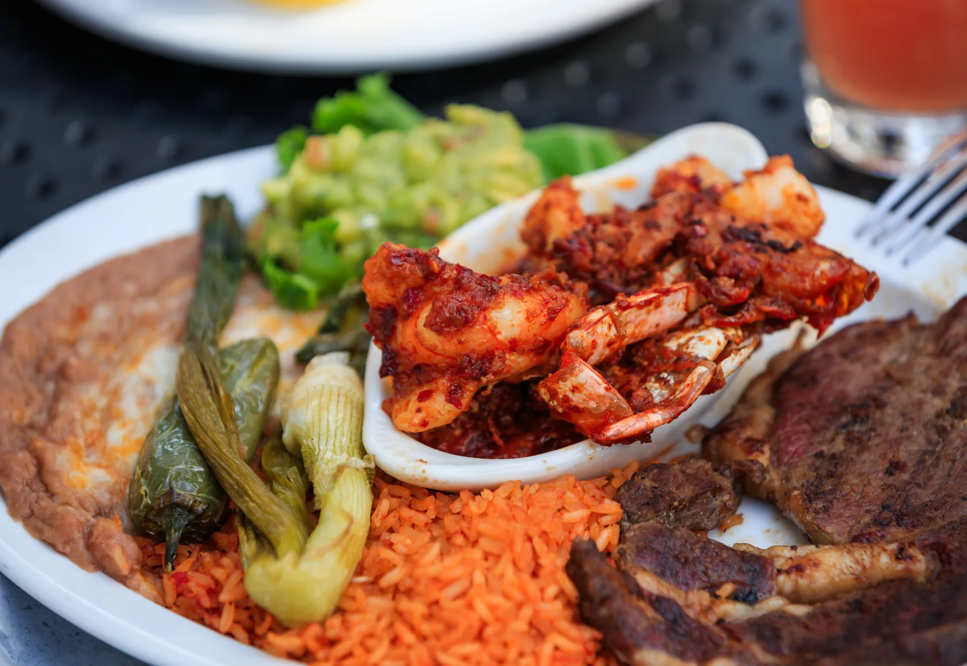 Grilled seafood platter with rice, vegetables and traditional sides