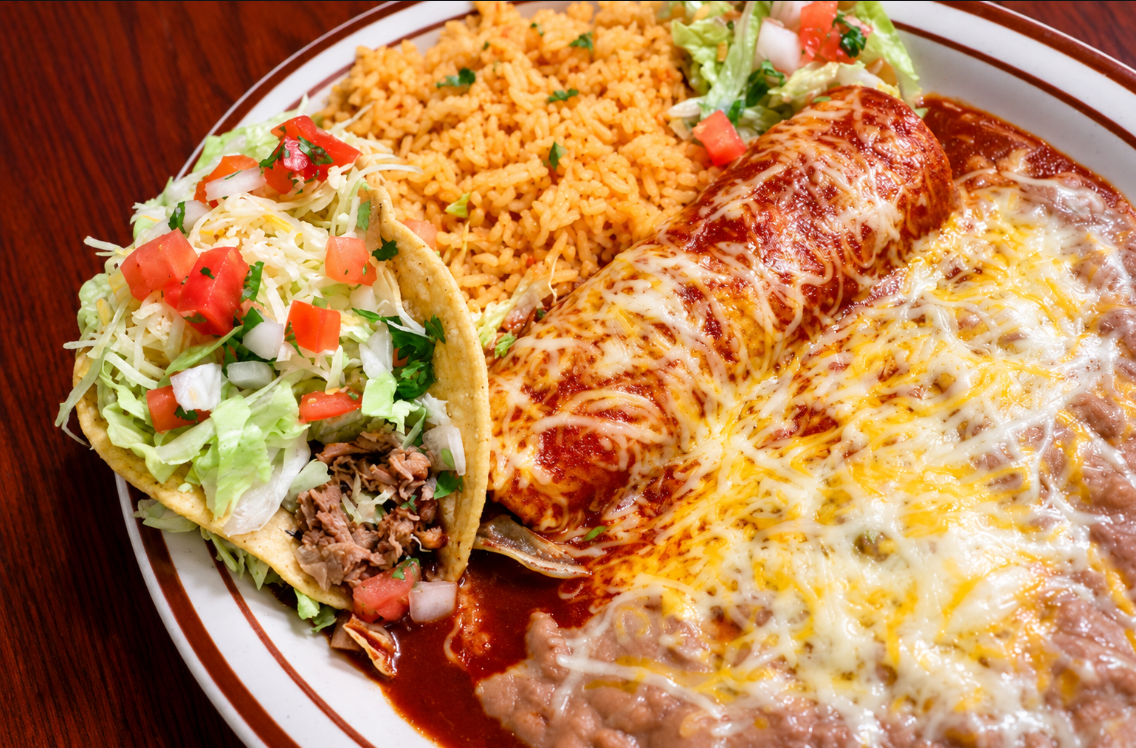 Combination plate with a shredded beef taco, cheese enchilada, rice, beans and salad