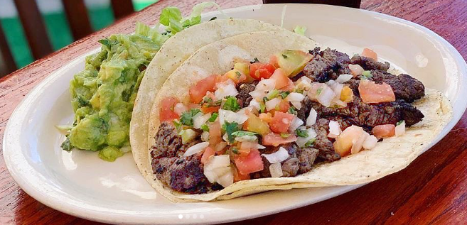 Carne asada taco topped with pico de gallo, served with guacamole