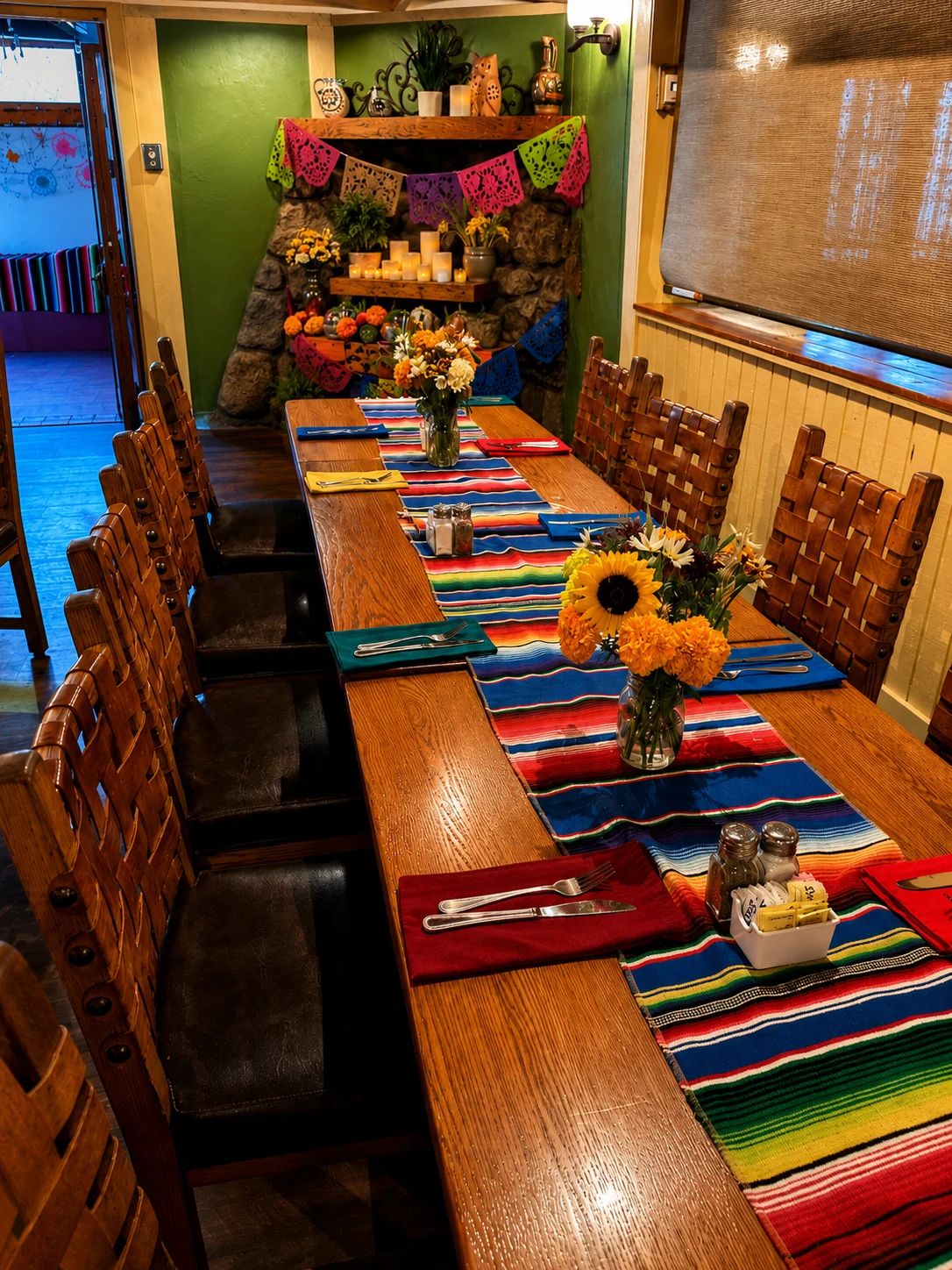 Colorful table runners, flowers and papel picado by the fireplace