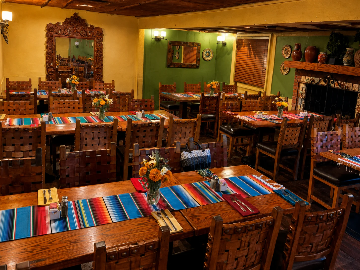 Wooden dining tables with colorful striped runners and flowers