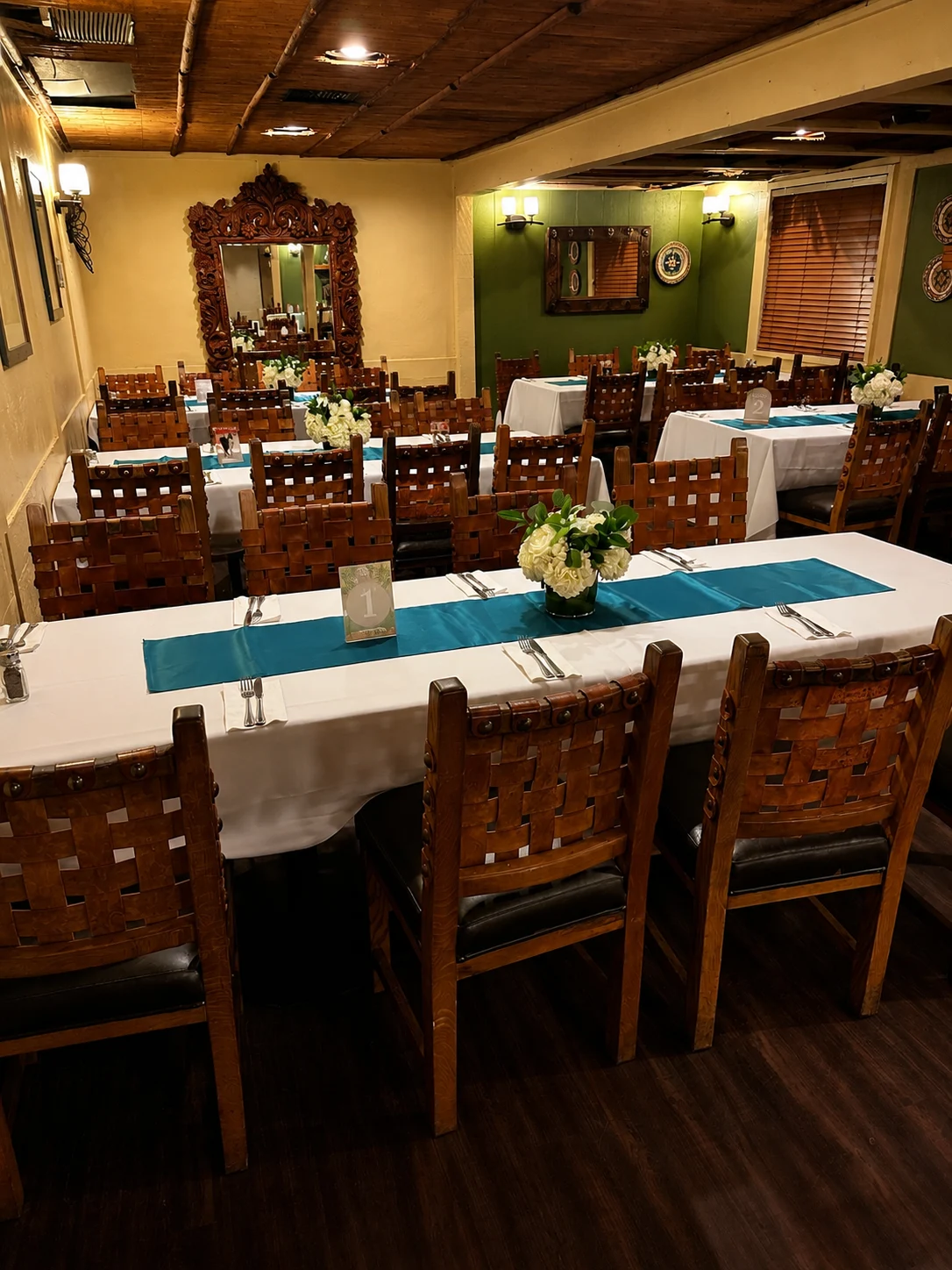 Tables with white linens, turquoise runners and white flowers