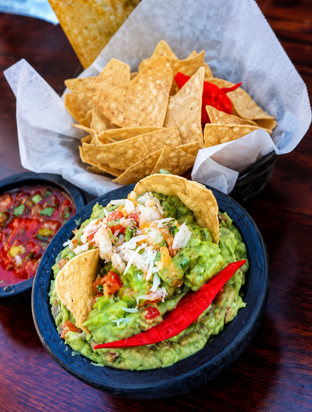 Fresh guacamole with tortilla chips and salsa