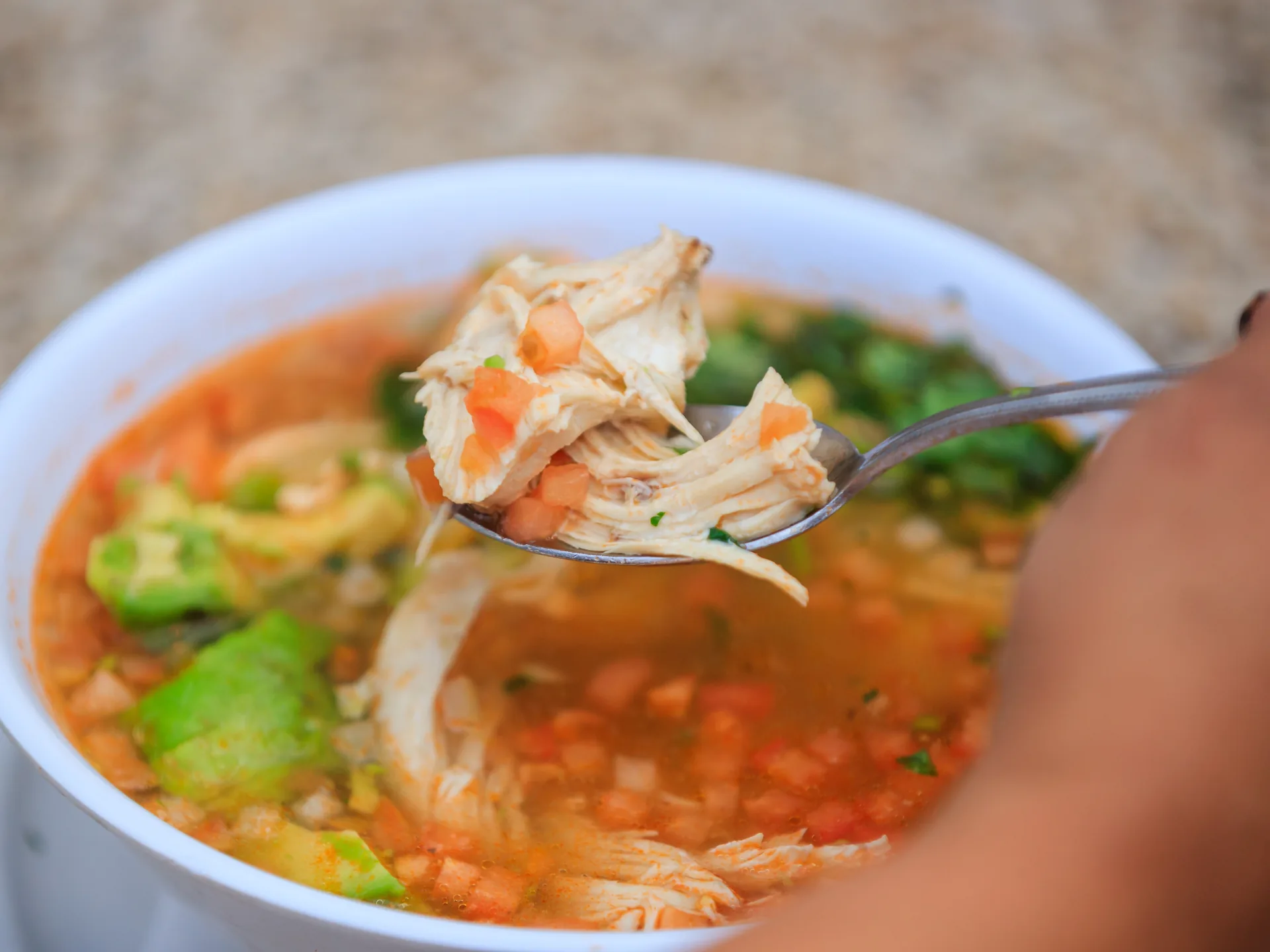 Chicken soup with fresh vegetables and herbs