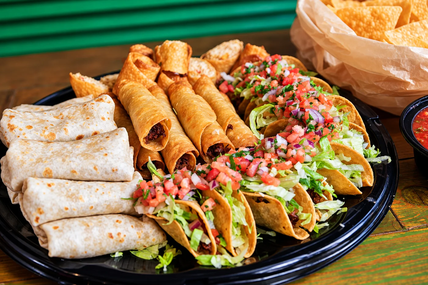 Tacos, flautas and burritos on a party platter