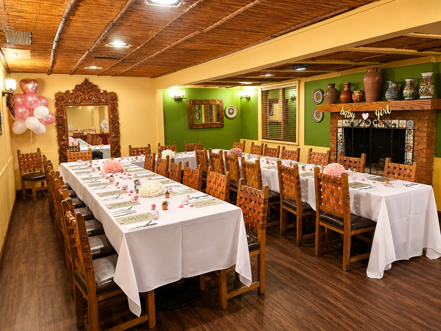 Tables decorated with pink flowers and baby shower balloons