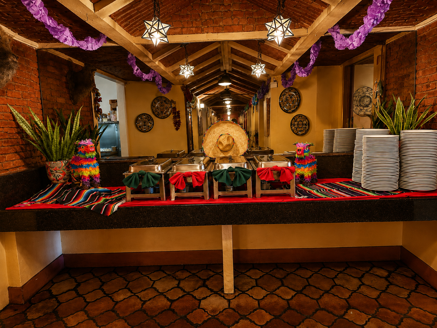 Festive buffet line with chafing dishes, piñatas and serape runners